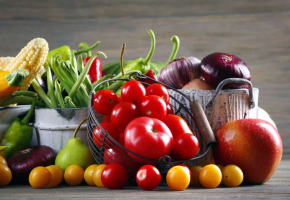 Heap of fresh fruits and vegetables on wooden background
